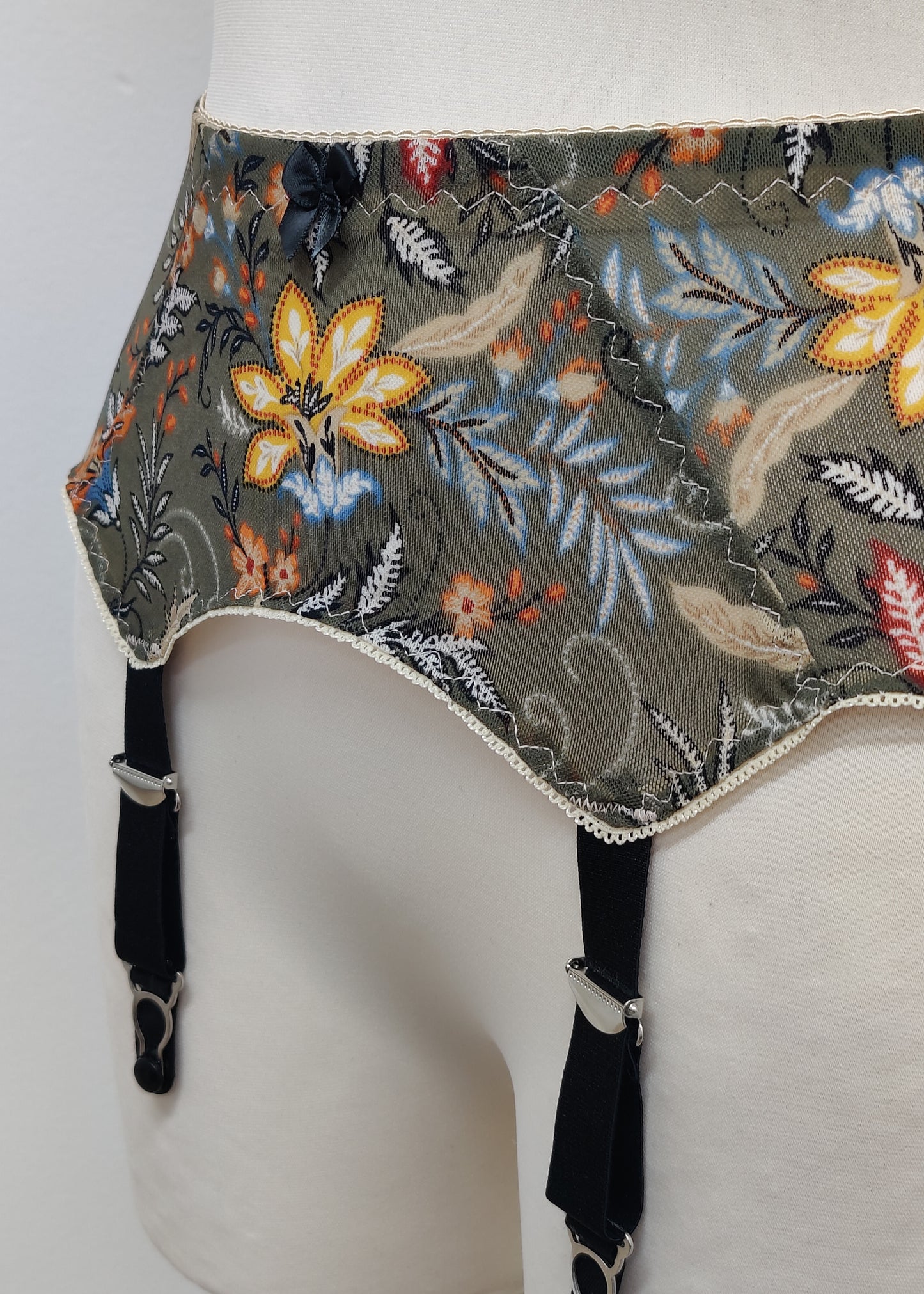 retro style Leilani suspender belt, made with olive green floral mesh fabric, with 6 wide straps, detail