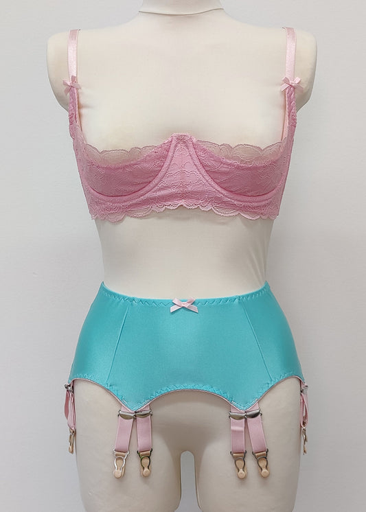 aqua blue 12 strap Joan garter belt with pink straps shown with pink Lucrezia quarter cup bra