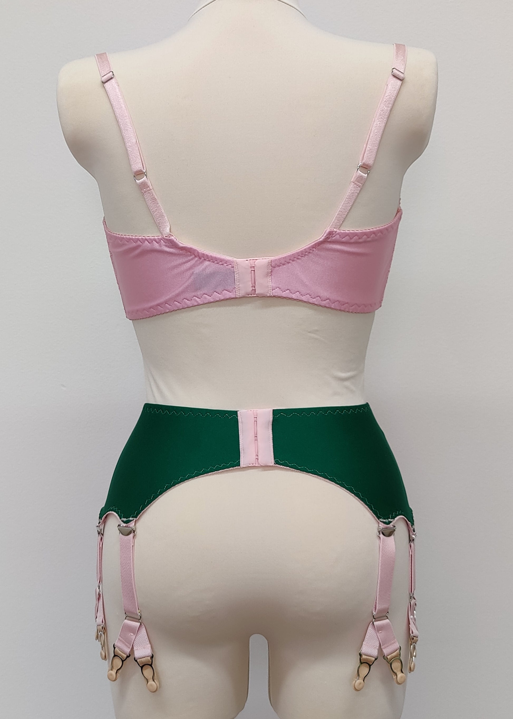 emerald green Jean garter belt with 8 pink Y-straps, shown with pink Lucrezia quarter cup bra, back view