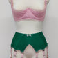emerald green Jean garter belt with 8 pink Y-straps, shown with pink Lucrezia quarter cup bra