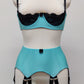 baby blue 12 strap Joan garter belt with black straps, shown with matching Lucy quarter cup bra