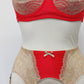 Red quarter cup Lucy bra with beige lace, straps and trims, here shown with matching retro style Mona garter belt , detail