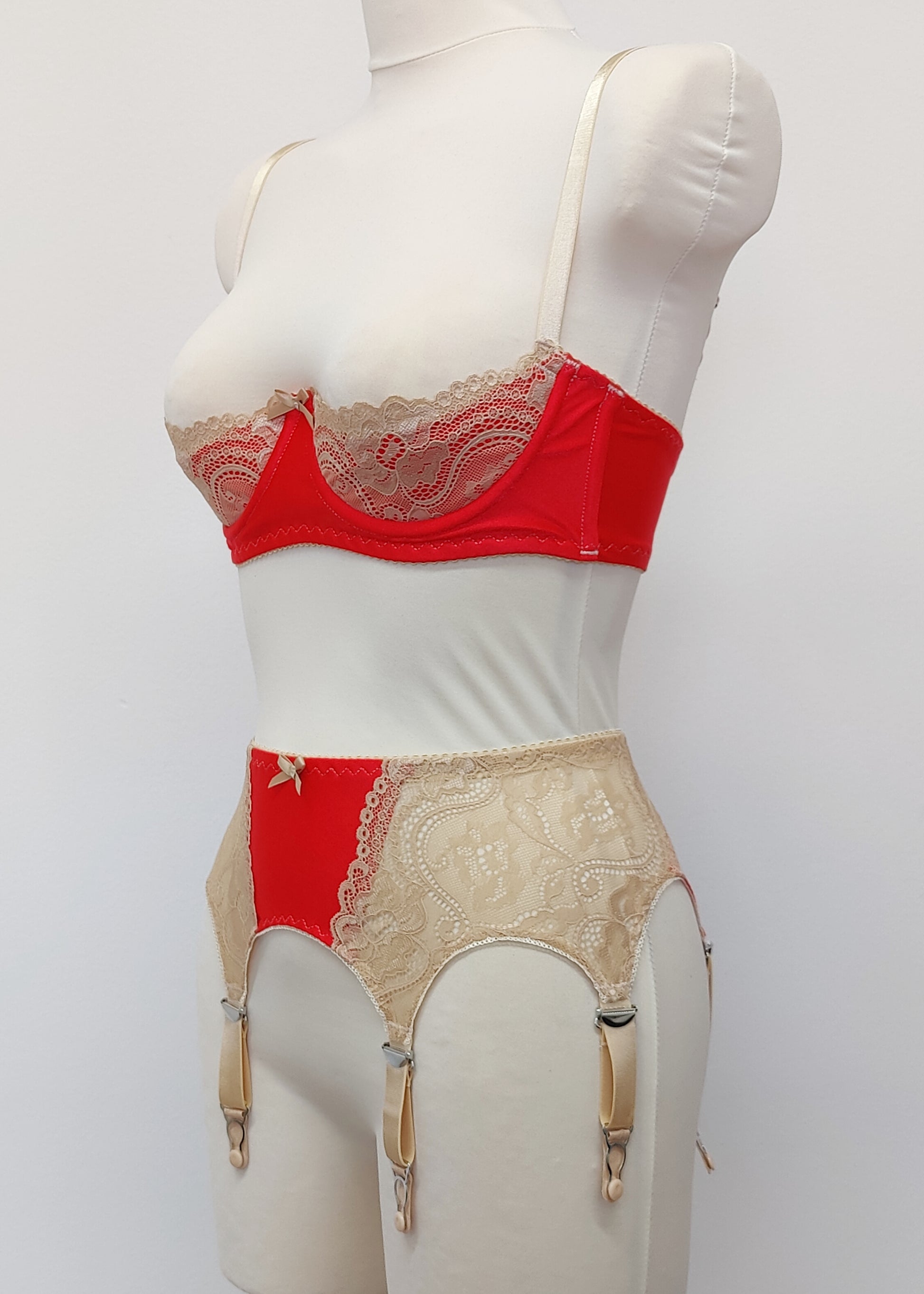 Red quarter cup Lucy bra with beige lace, straps and trims, here shown with matching retro style Mona garter belt, side view