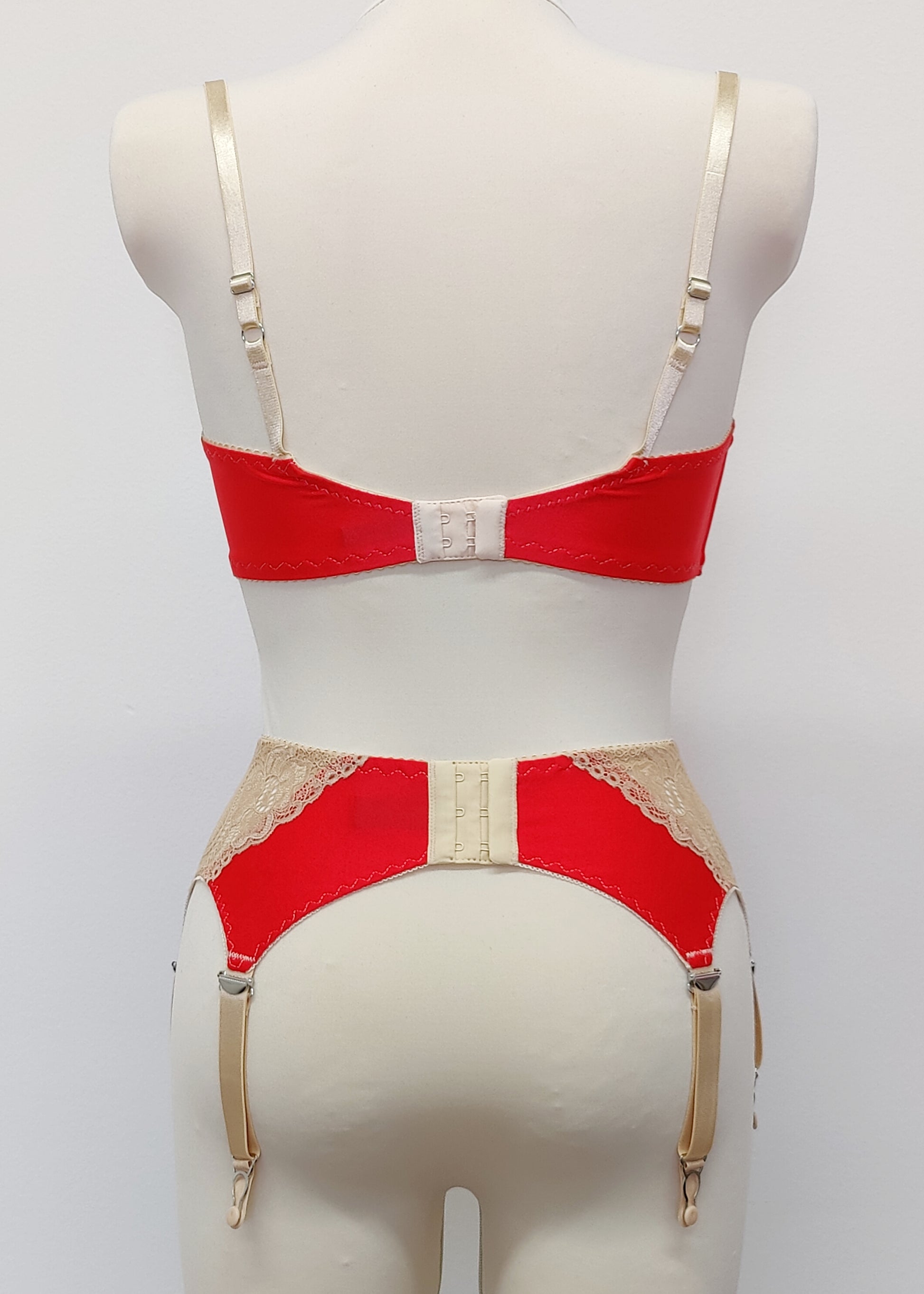 Red quarter cup Lucy bra with beige lace, straps and trims, here shown with matching retro style Mona garter belt , back view