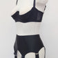 Black Iris garter belt with 6 extra wide straps and with larger bows on the front straps, shown here with matching quarter cup Gina bra, side view