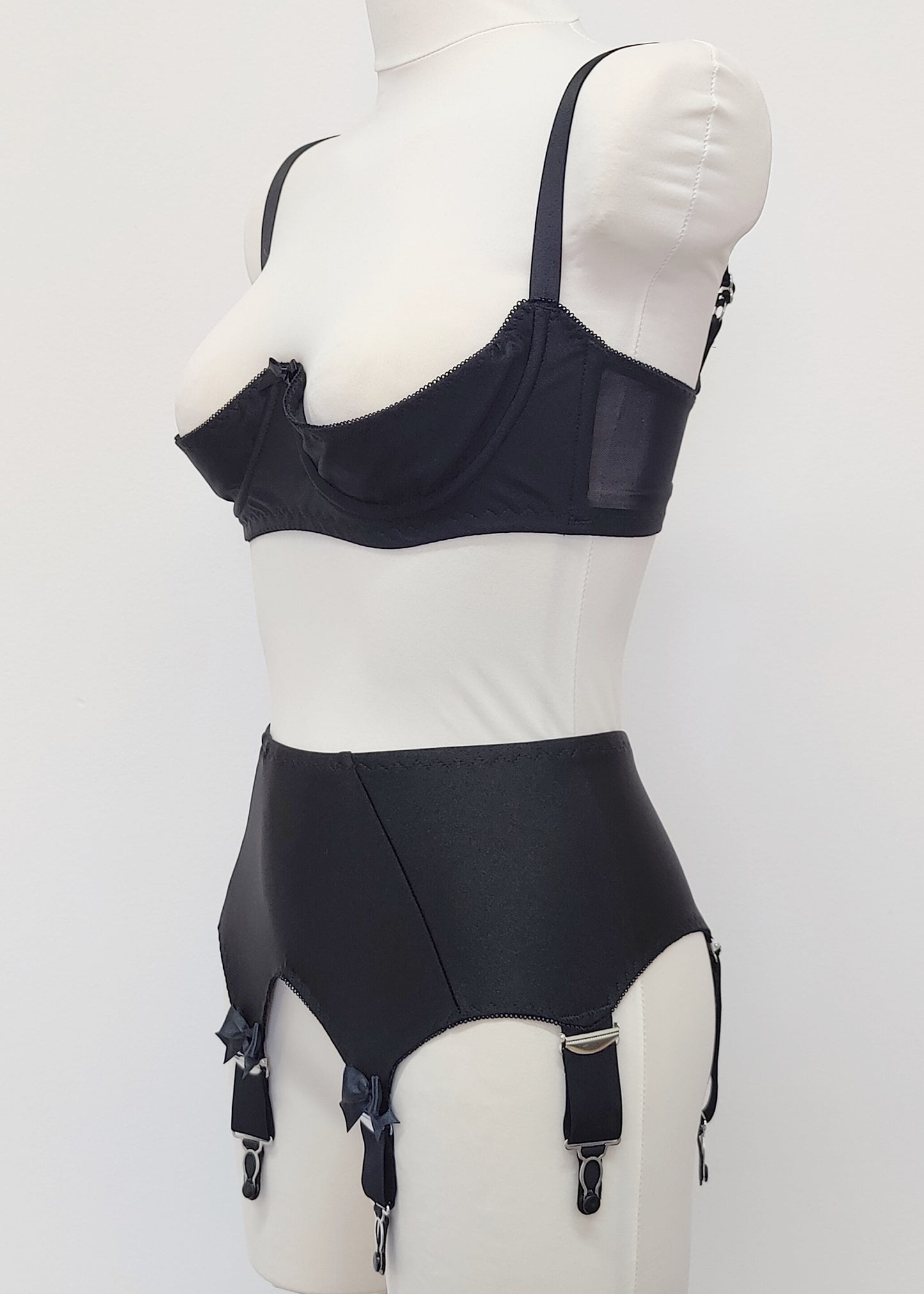 Black Iris garter belt with 6 extra wide straps and with larger bows on the front straps, shown here with matching quarter cup Gina bra, side view