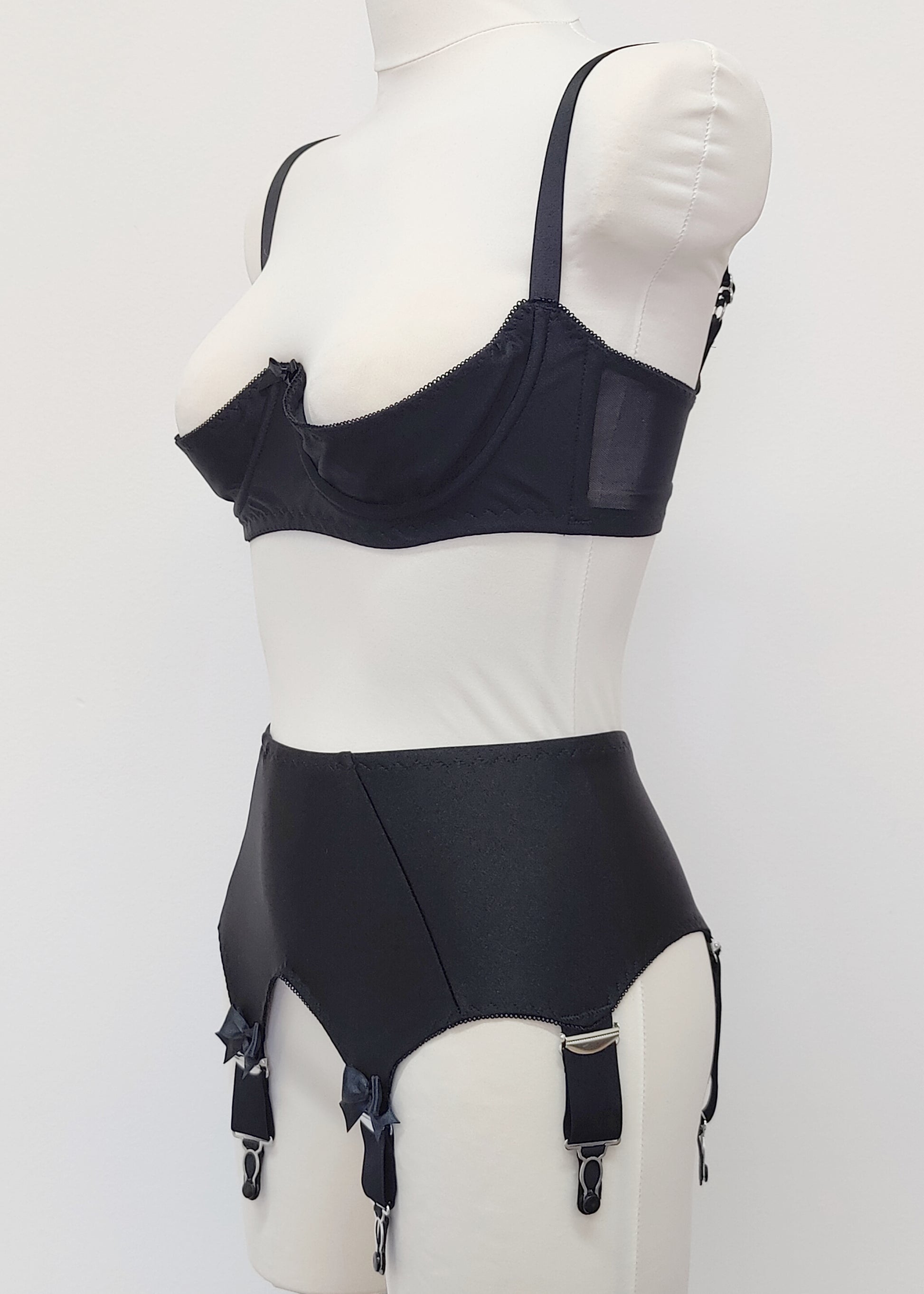 Black Iris garter belt with 6 extra wide straps and with larger bows on the front straps, shown here with matching quarter cup Gina bra, side view