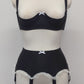 black 6 strap Gigi garter belt with white ruffle trim and bow