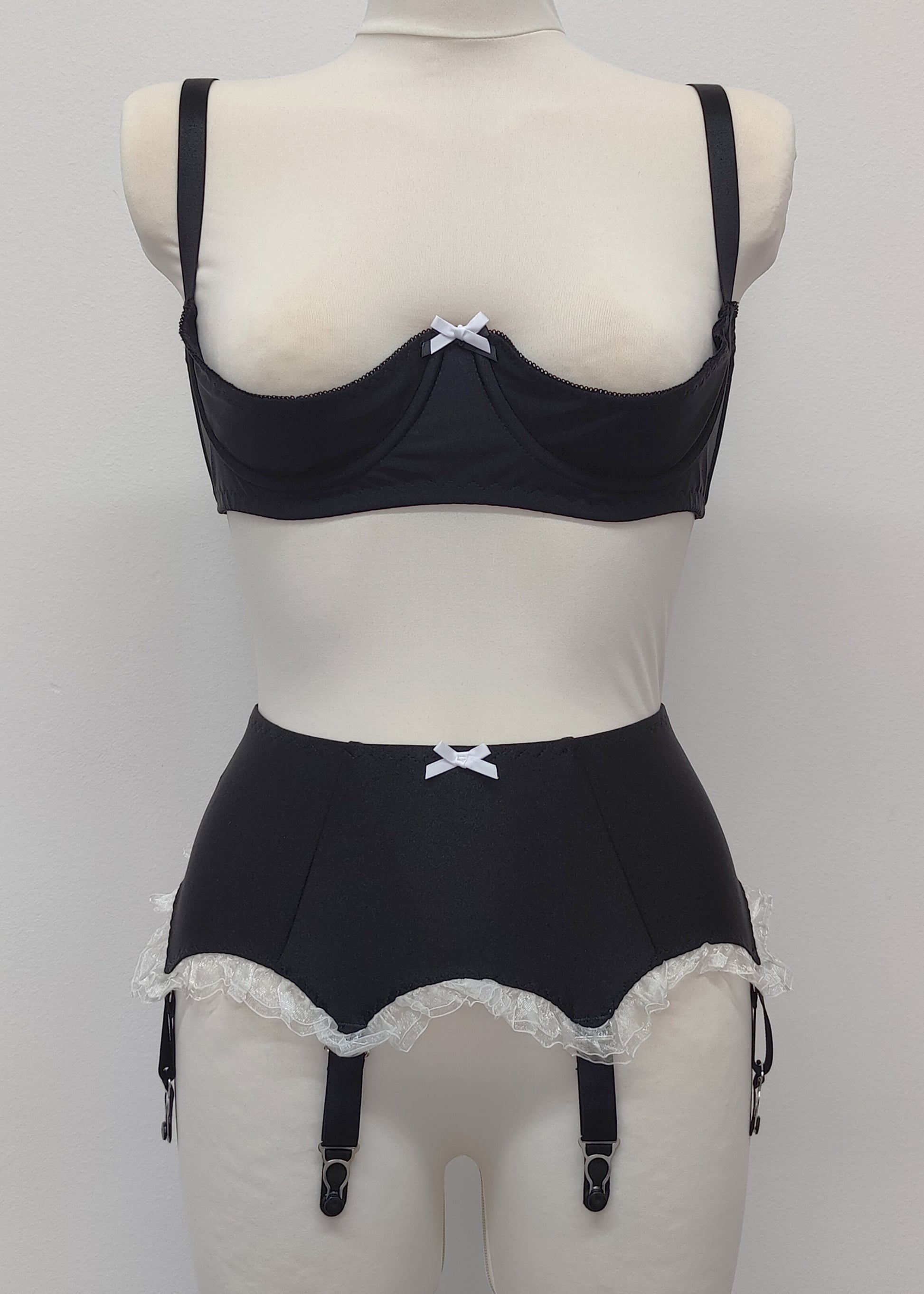 black 6 strap Gigi garter belt with white ruffle trim and bow