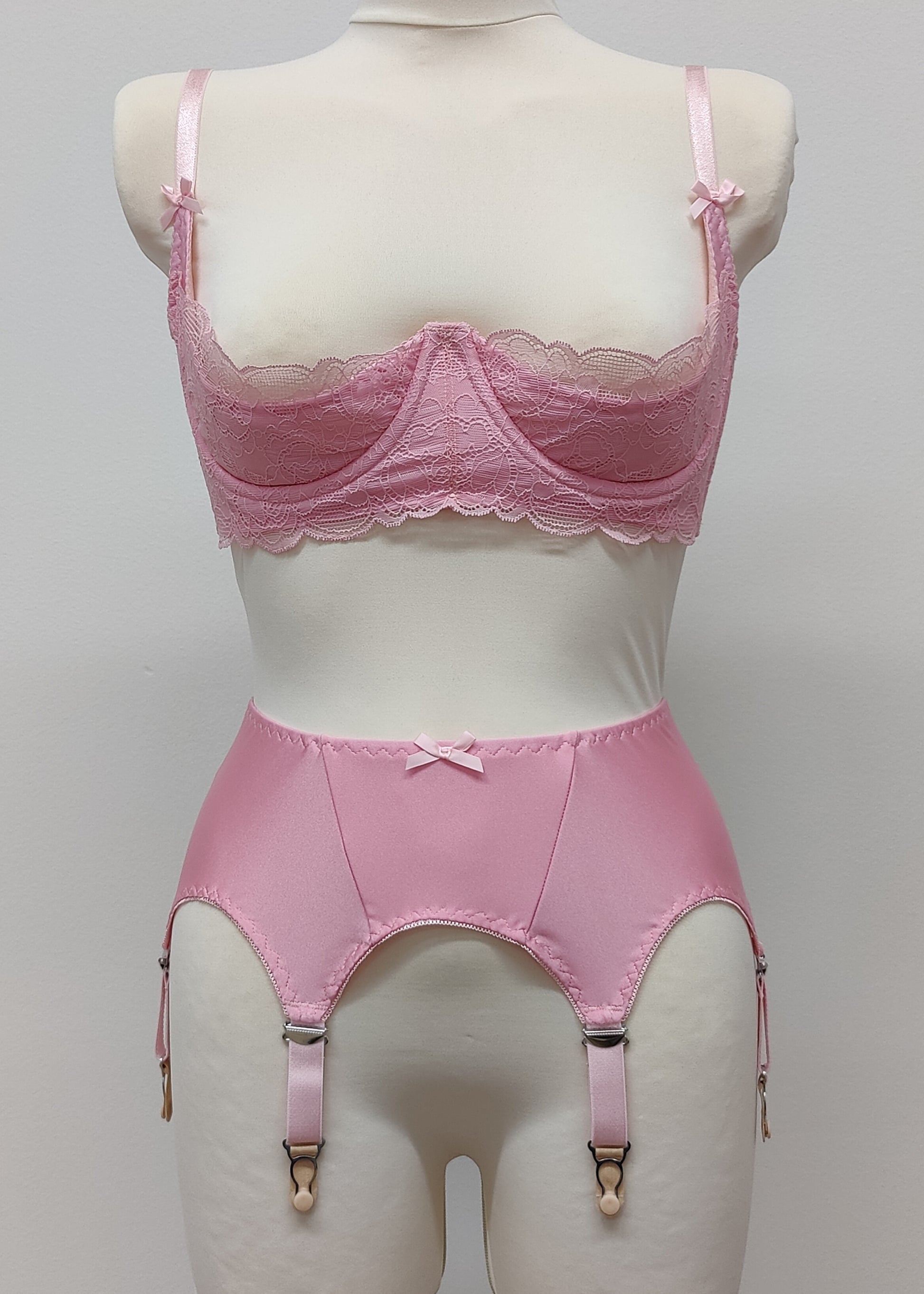 Pink narrow Nina garter belt, 60's style with 6 adjustable straps and hook and eye closure at the back. Shown with matching Lucrezia quarter cup bra.