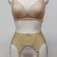 Beige narrow Nina garter belt, 60's style with 6 adjustable straps and hook and eye closure at the back. Shown with matching  bra.