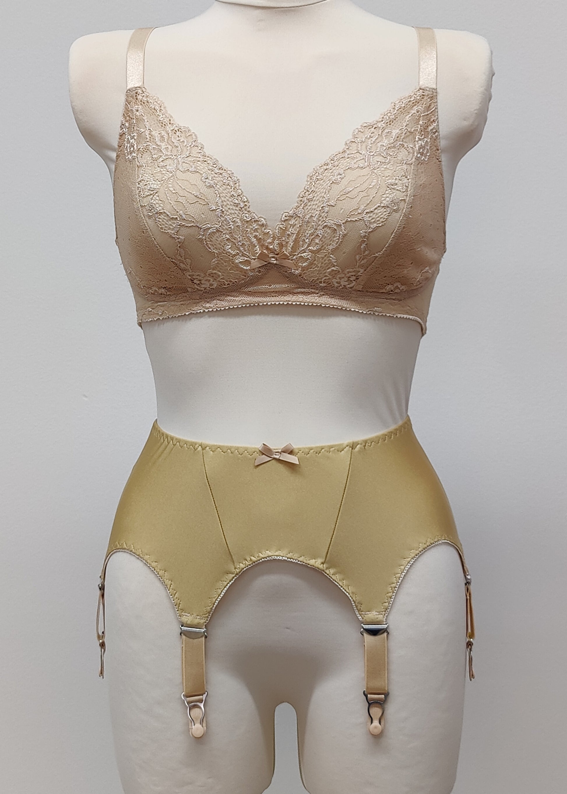 Beige narrow Nina garter belt, 60's style with 6 adjustable straps and hook and eye closure at the back. Shown with matching  bra.