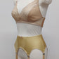 Beige narrow Nina garter belt, 60's style with 6 adjustable straps and hook and eye closure at the back. Shown with matching  bra, side view