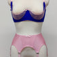 Quarter cup Lucy bra, here shown in blue with pink lace, straps and trims. On the photo is also Nina 6 strap garter belt in pink. 