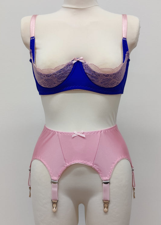 Quarter cup Lucy bra, here shown in blue with pink lace, straps and trims. On the photo is also Nina 6 strap garter belt in pink. 