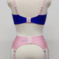 Quarter cup Lucy bra, here shown in blue with pink lace, straps and trims. On the photo is also Nina 6 strap garter belt in pink. Back view
