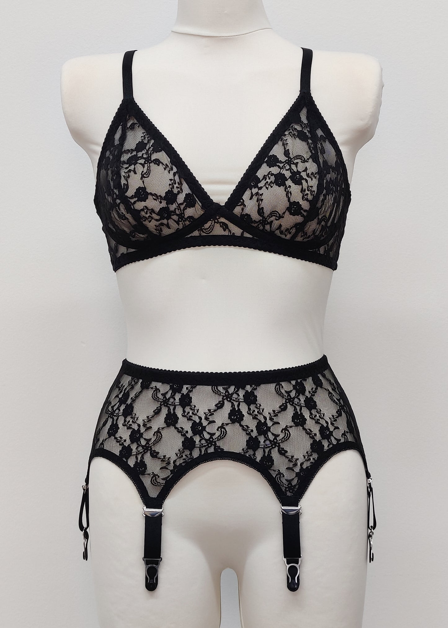 Claire is a black lace garter belt with 4-8 adjustable straps, displayed on a mannequin with matching wireless Chloe bralette