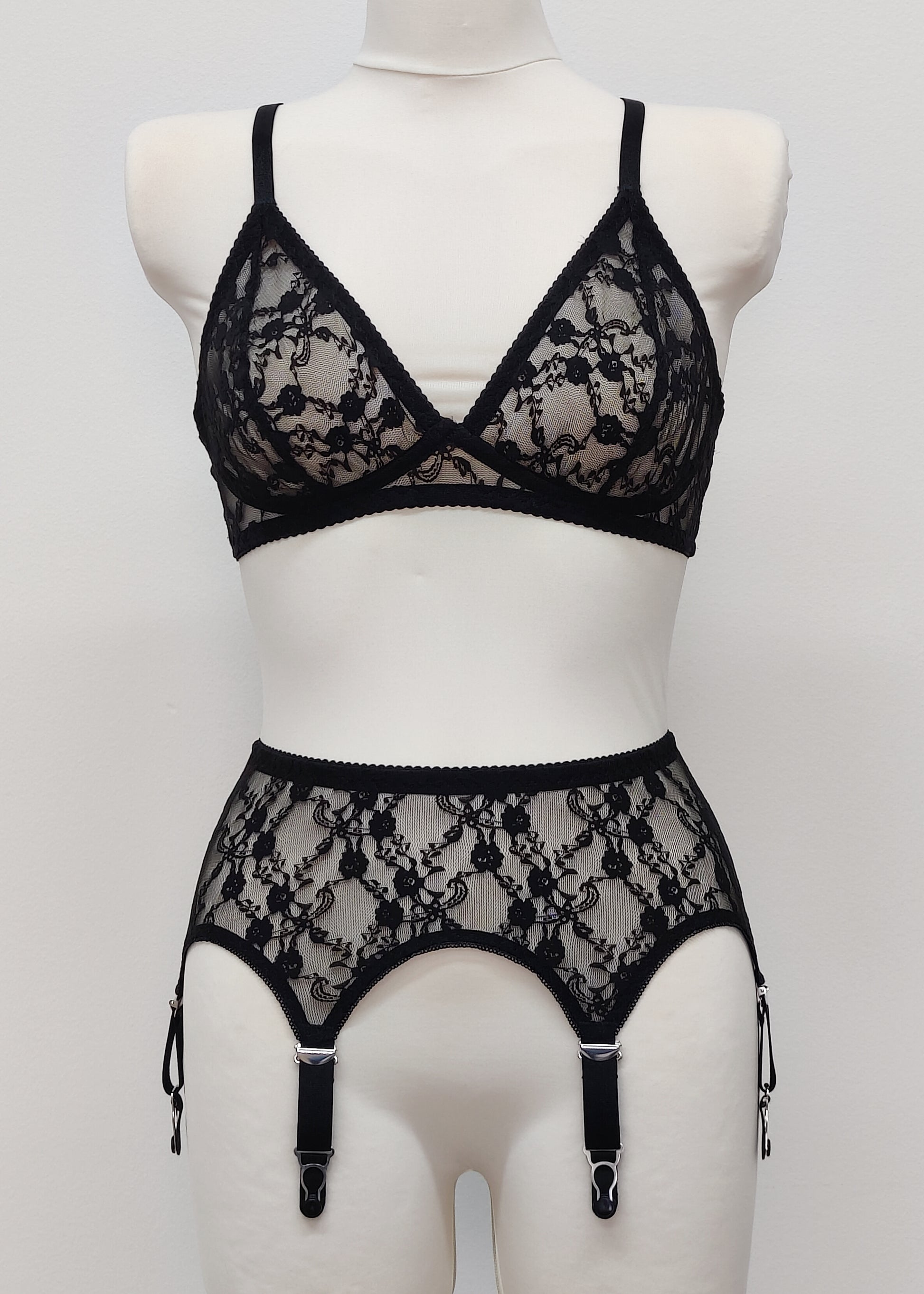 Claire is a black lace garter belt with 4-8 adjustable straps, displayed on a mannequin with matching wireless Chloe bralette