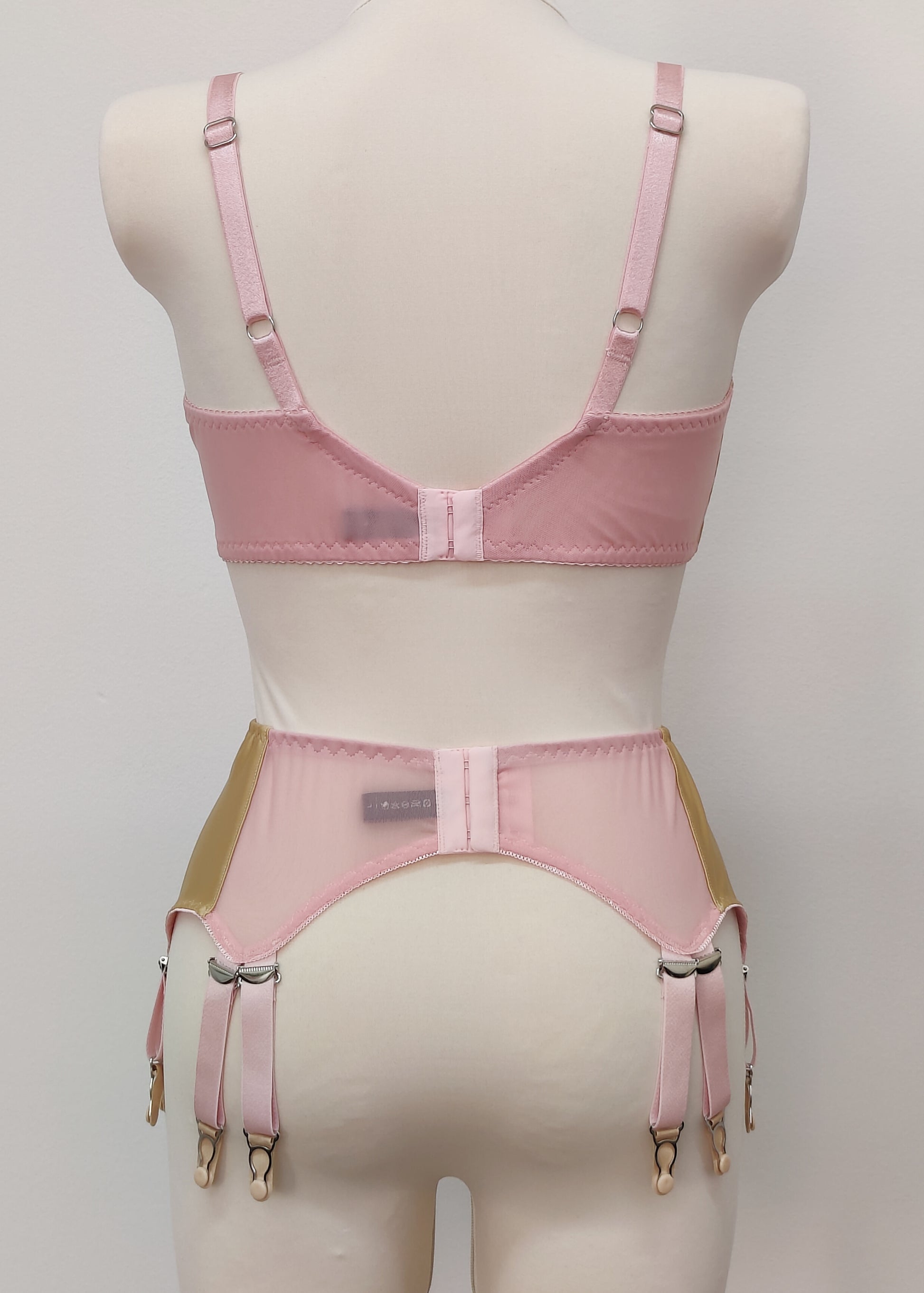 beige Audrey bra with pink sheer upper part of the cup,straps and trim, here shown with matching Stella garter belt, back view