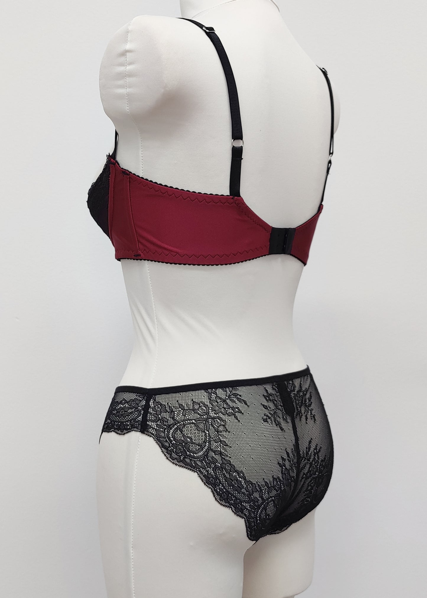 Black lace and maroon Lycra quarter cup Lucy bra, here shown with matching Zigi panties, back side view