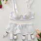 White lace lingerie set with garter belt on a light background with flowers.