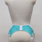 A white lace and Aqua blue Lycra, Mona garter belt with 6 adjustable straps and hook and eye closure, displayed on a mannequin. Back view