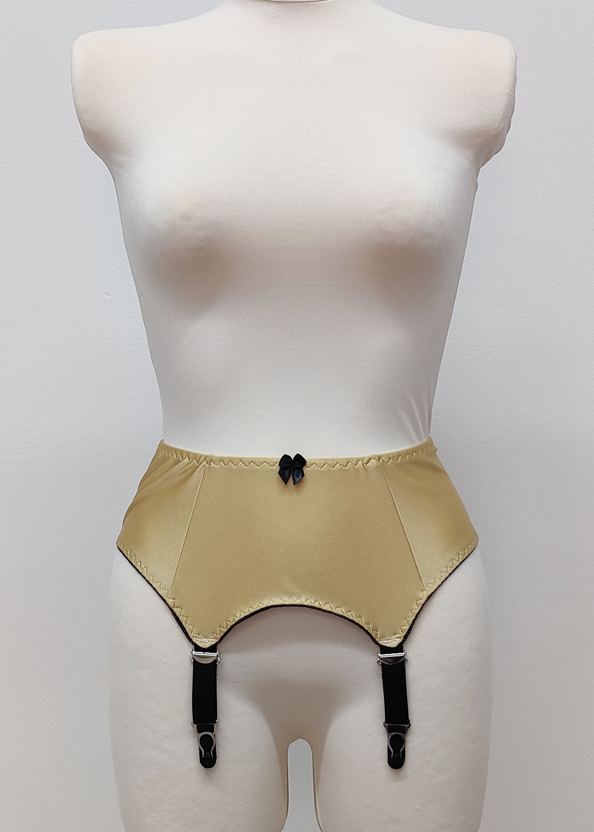 Beige Greta 4 strap garter belt with black straps on a mannequin against a white background