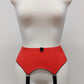 Sunset colour, 4 strap Greta garter belt with black straps on a mannequin against a white background