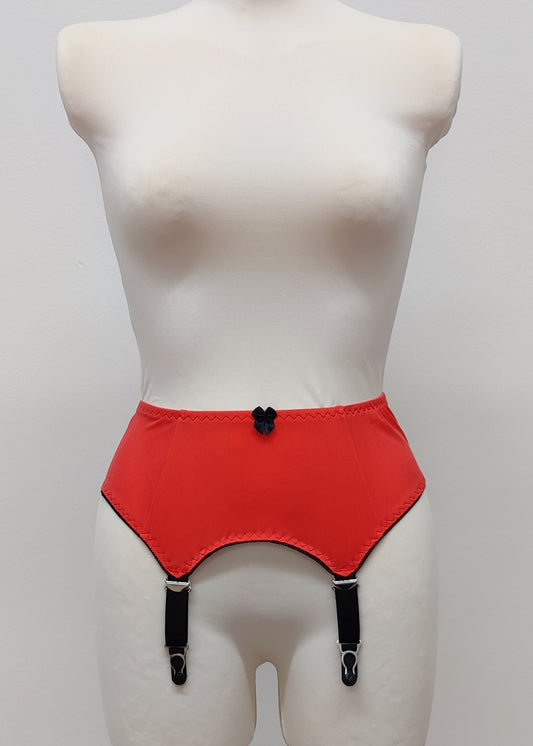 Sunset colour, 4 strap Greta garter belt with black straps on a mannequin against a white background