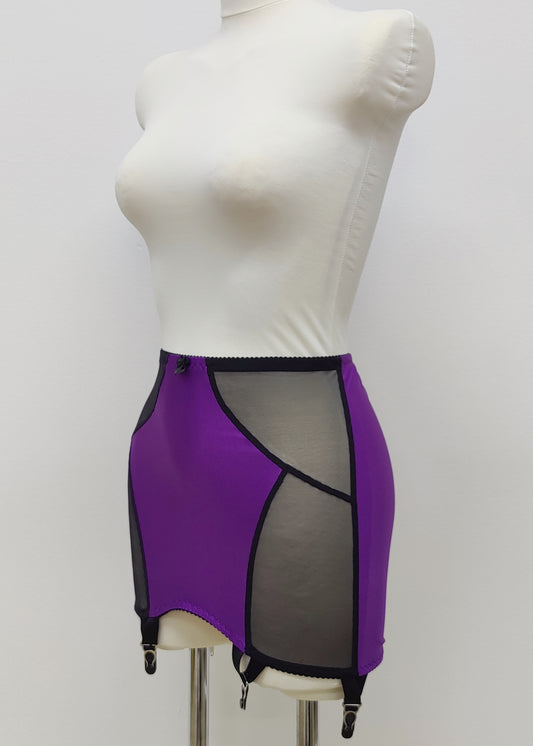 Open bottom Glenda girdle made with purple opaque front and back panels with black sheer mesh side panels. 