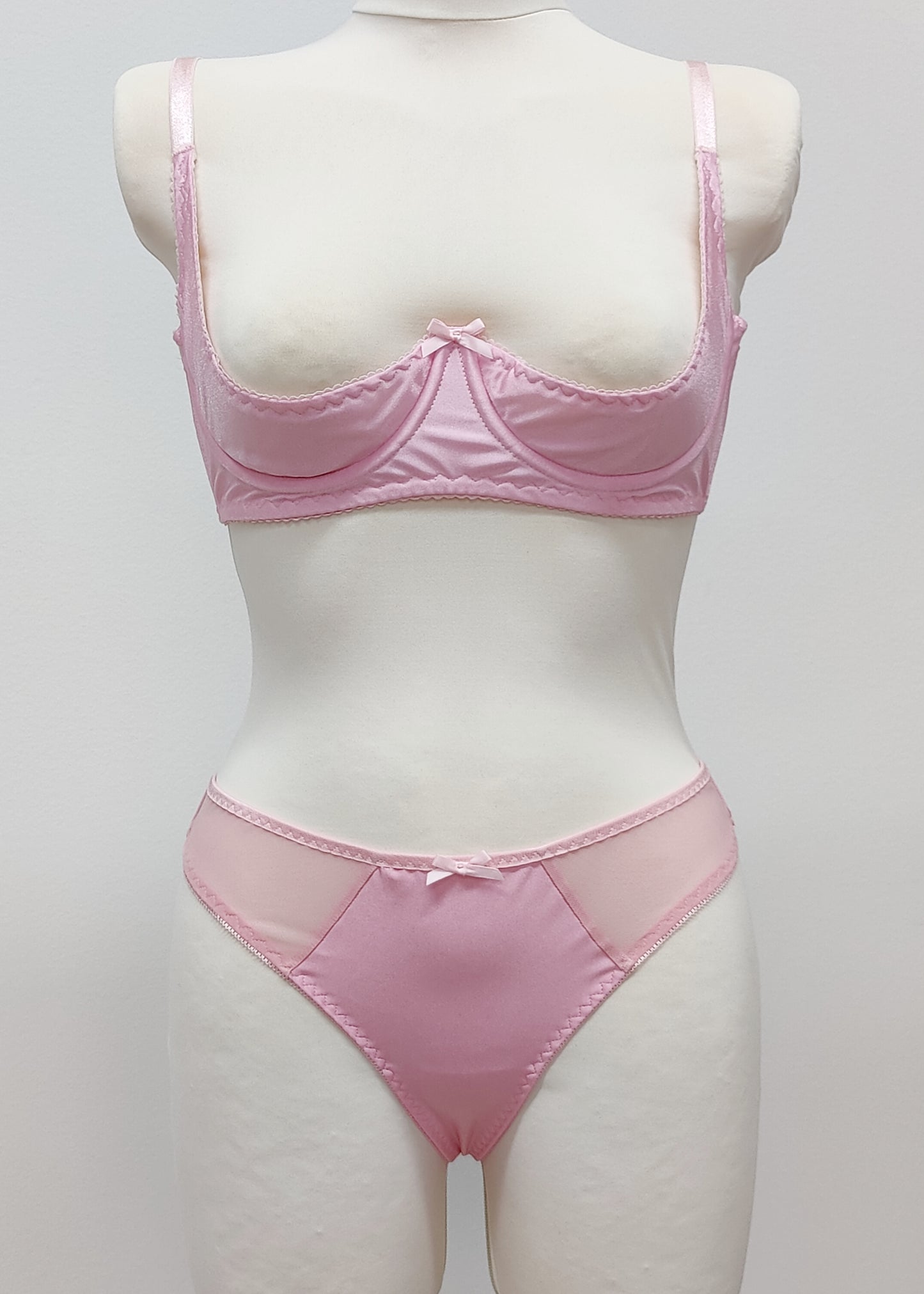 Mannequin wearing a  pink Gina quarter cup bra and  Mia thong with sheer side panels 