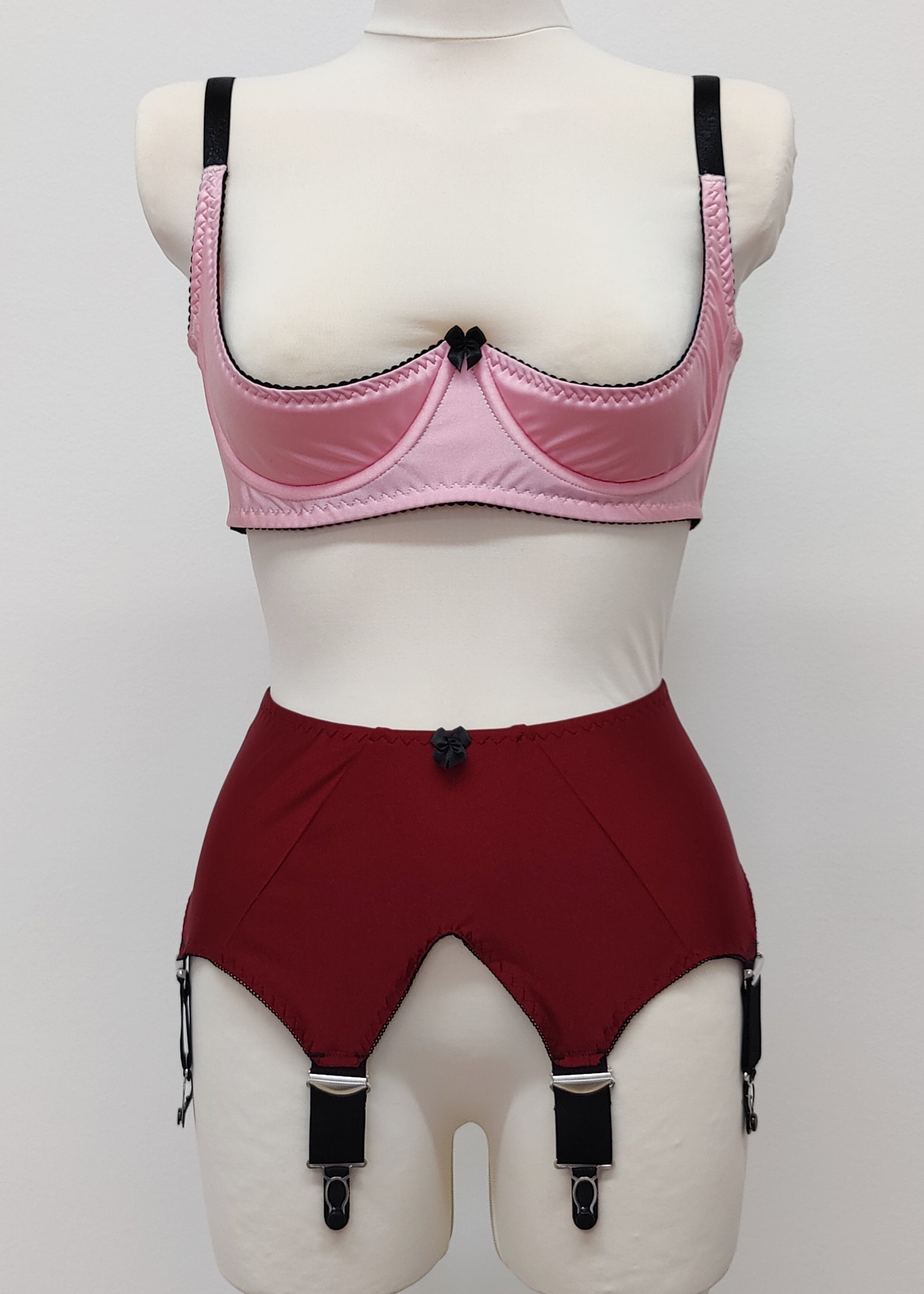 maroon high-waisted garter belt with extra wide black straps and bows