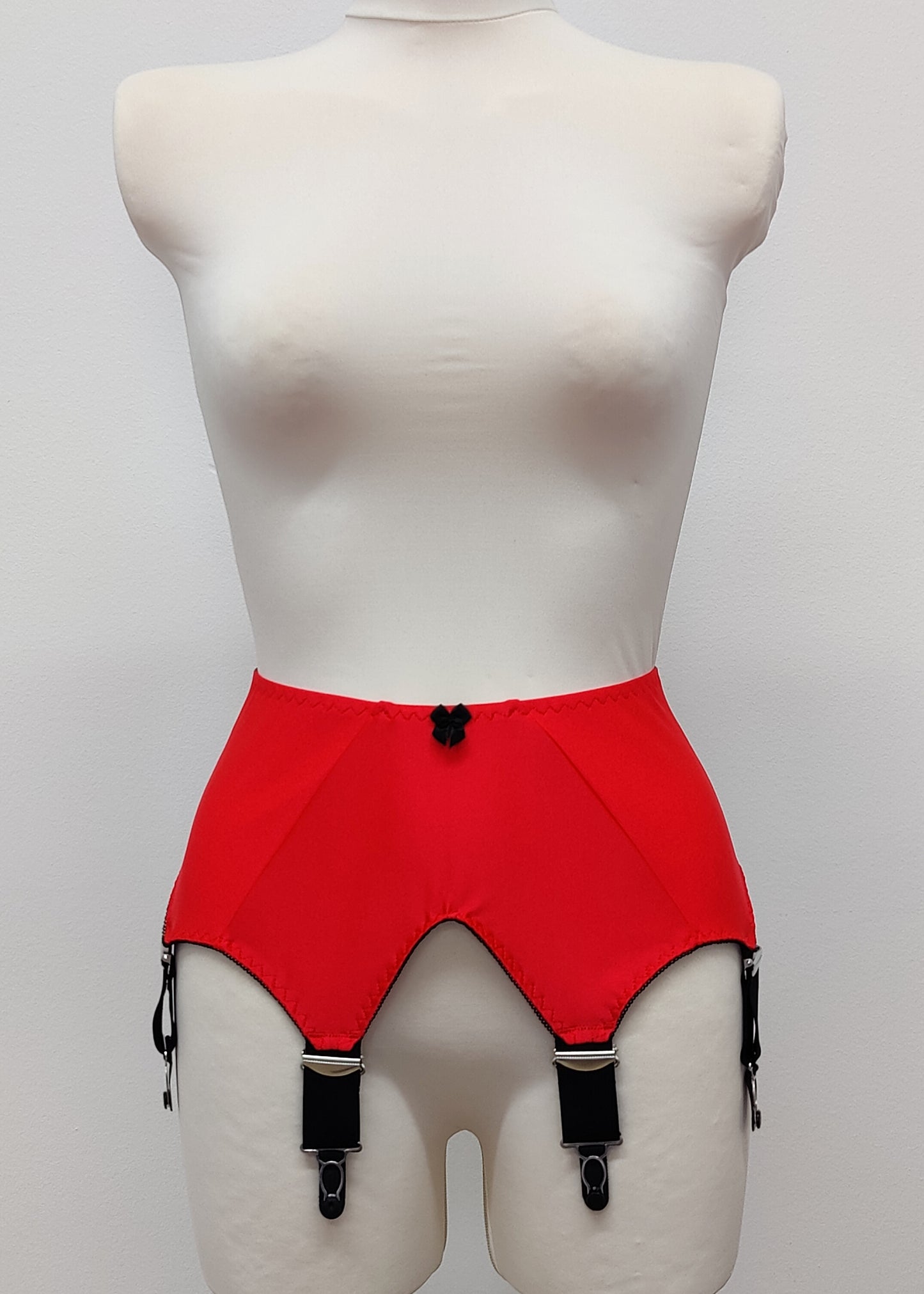 wide vintage style Iris garter belt in colour Sunset Red, with black trim and 6 extra wide black straps 