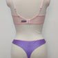 Mannequin wearing a pink Lucy bra and purple Mia thong underwear with pink sheer side panels , back view