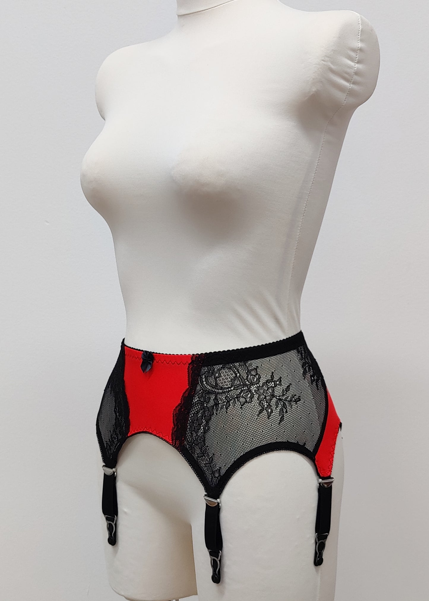 High waist Mona garter belt in red color with black lace side panels and 6 adjustable straps, side view