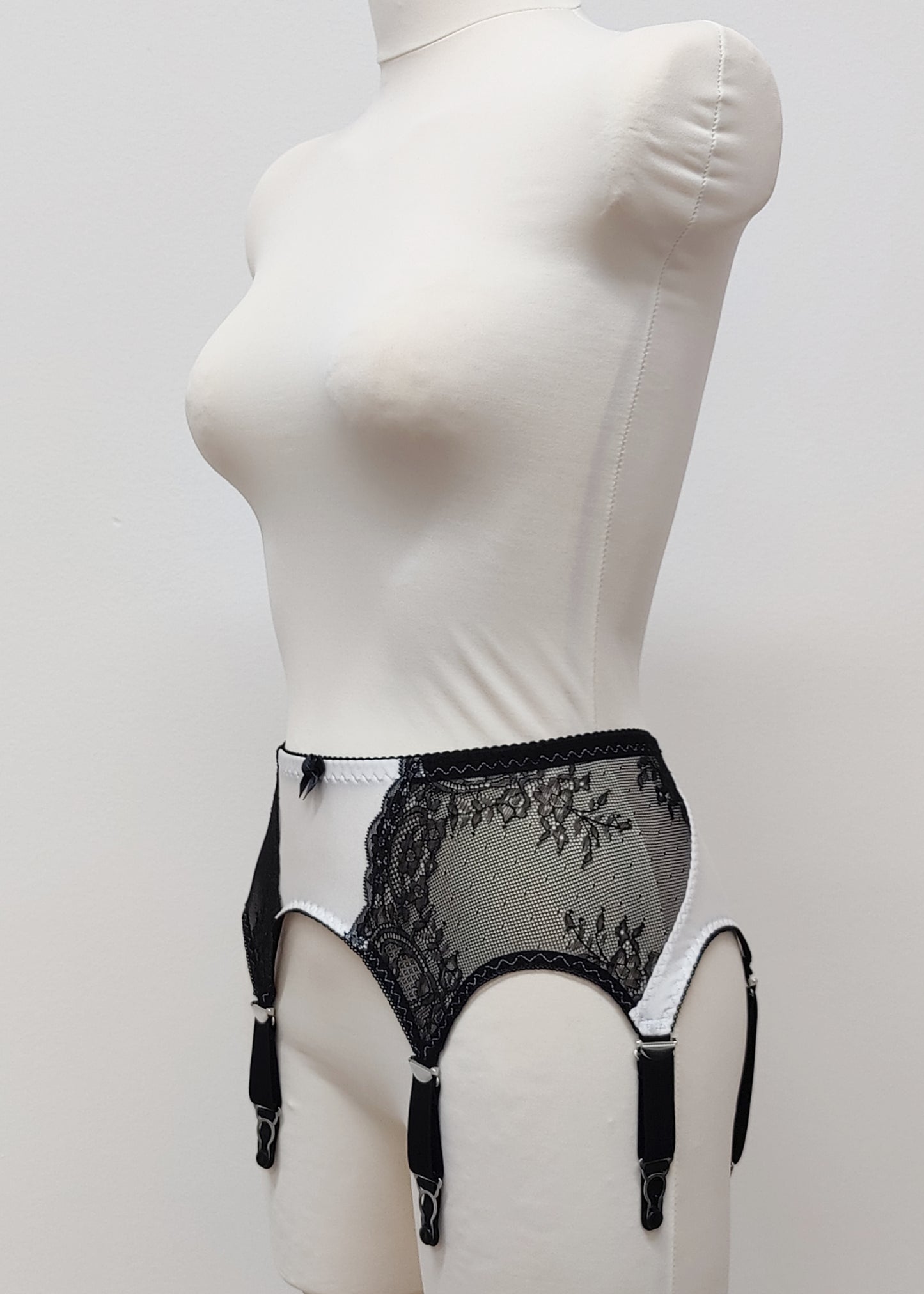 High waist Mona garter belt in white color with black lace side panels and 6 adjustable straps, side view