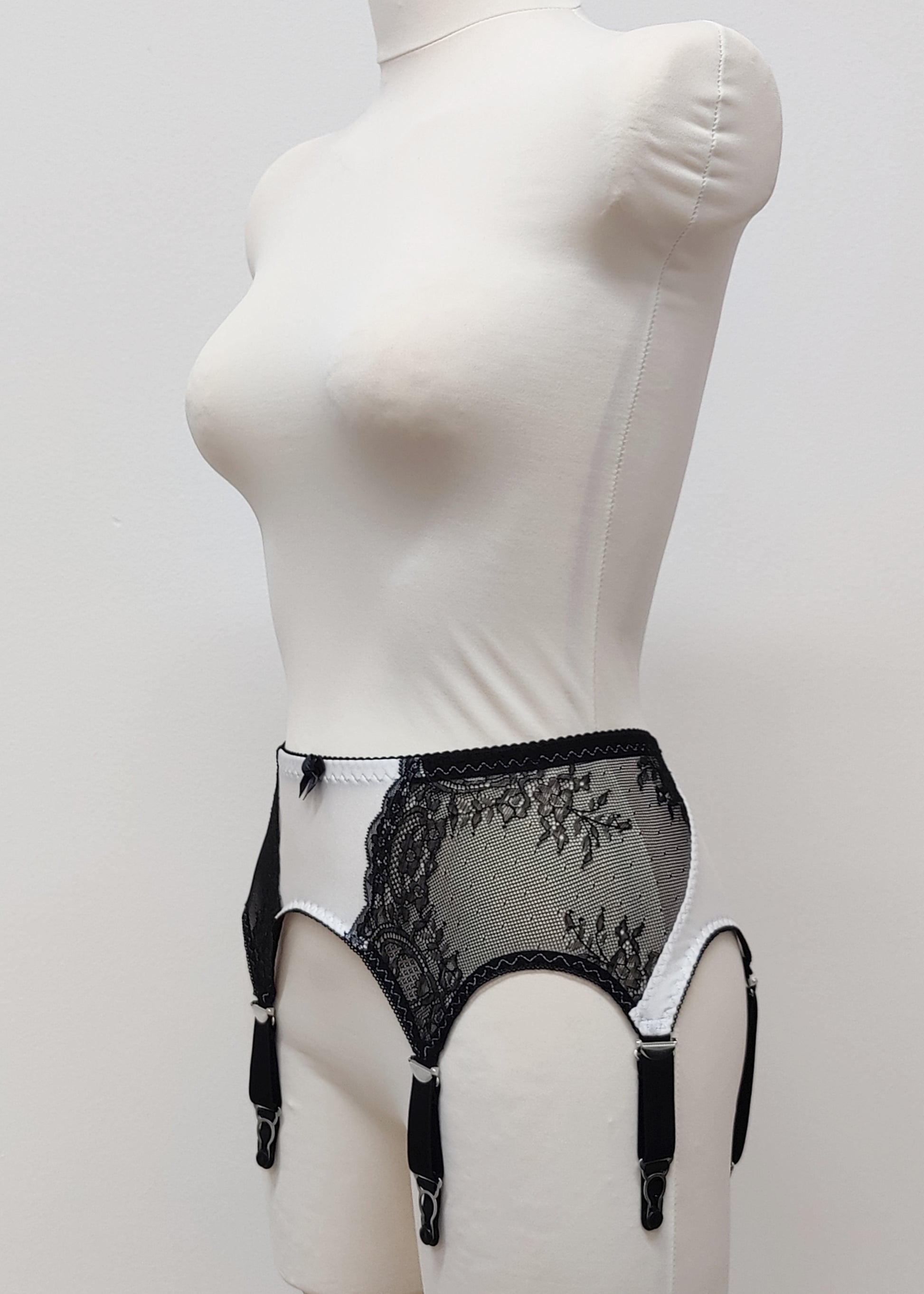 High waist Mona garter belt in white color with black lace side panels and 6 adjustable straps, side view