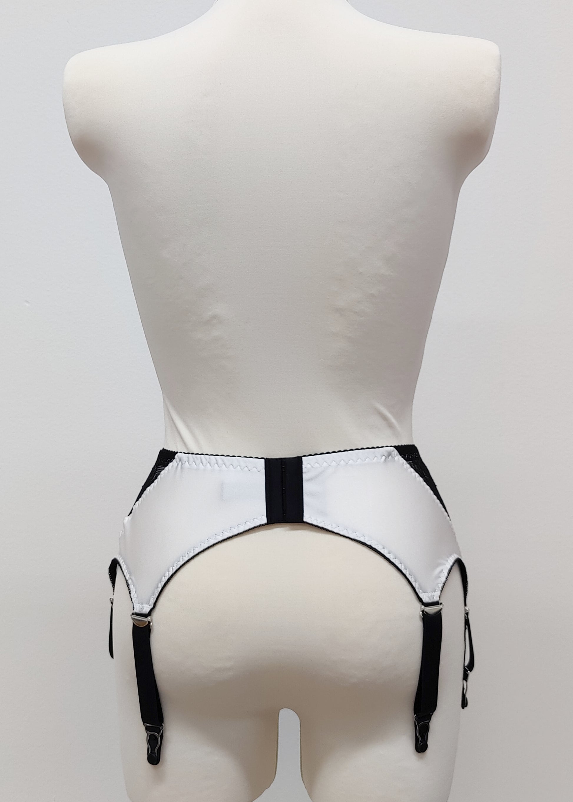 High waist Mona garter belt in white color with black lace side panels and 6 adjustable straps, back view