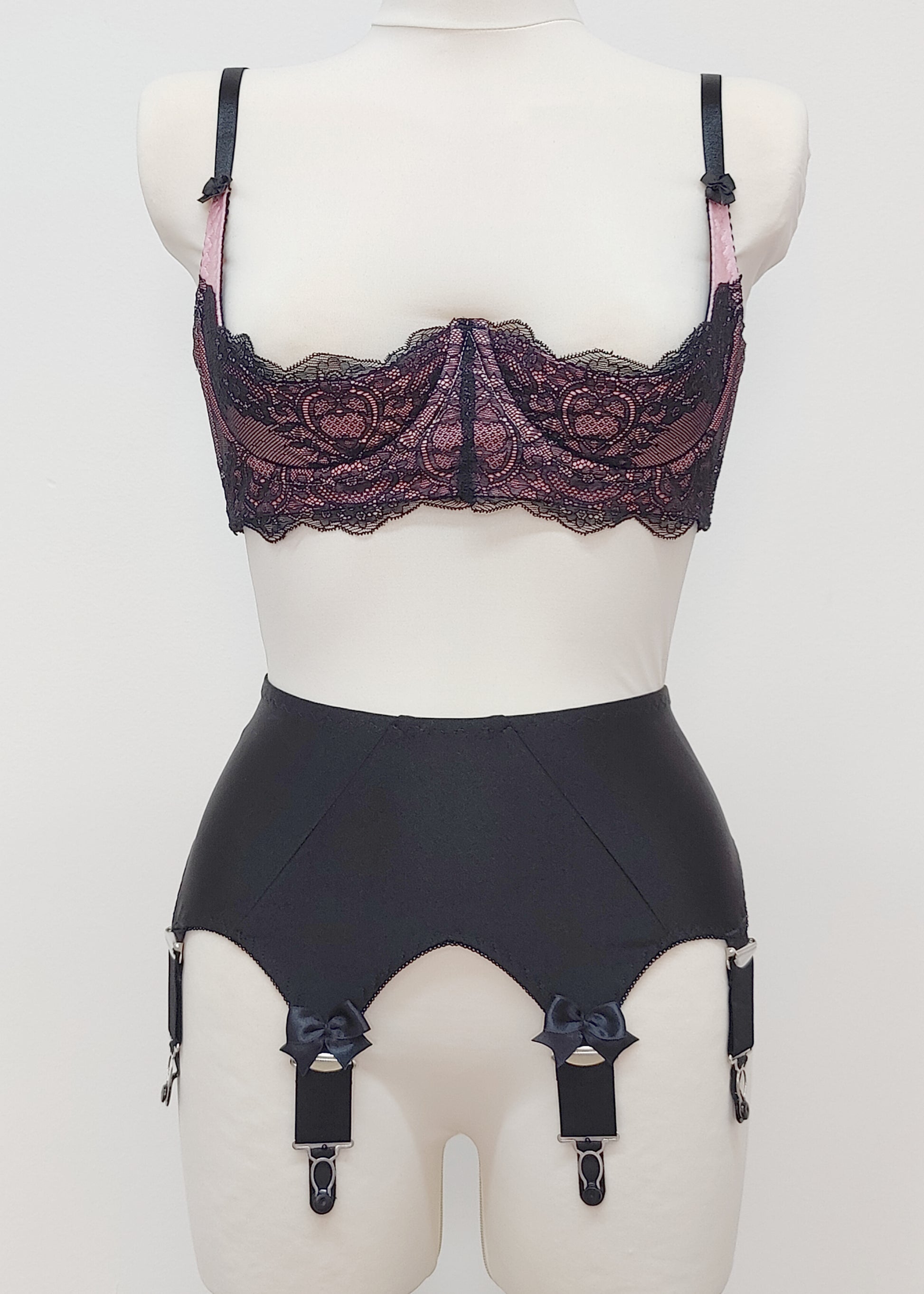 Black Iris garter belt with bows on the front straps, shown here with pink/black Lucrezia bra