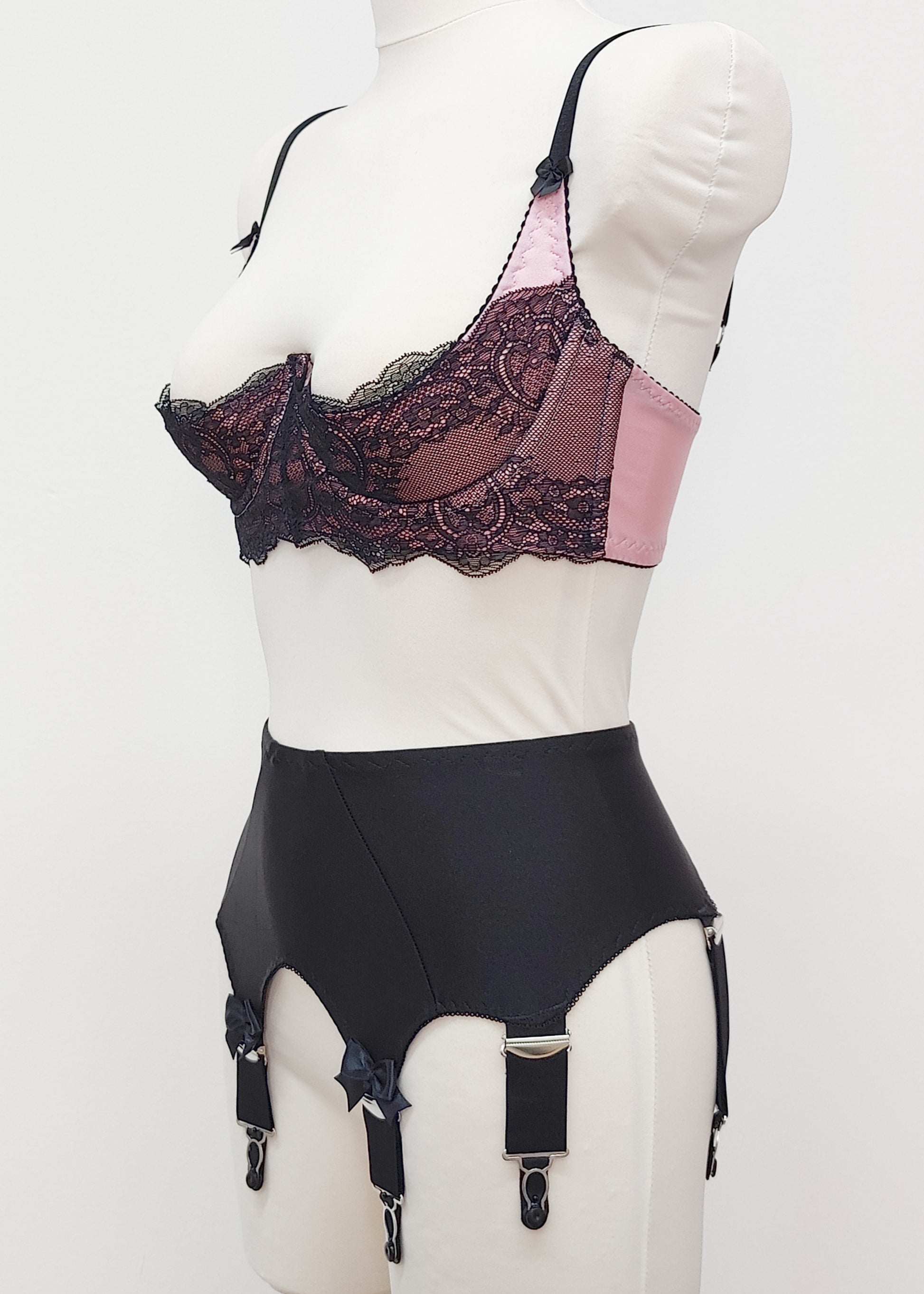 Black Iris garter belt with bows on the front straps, shown here with pink/black Lucrezia bra, side view
