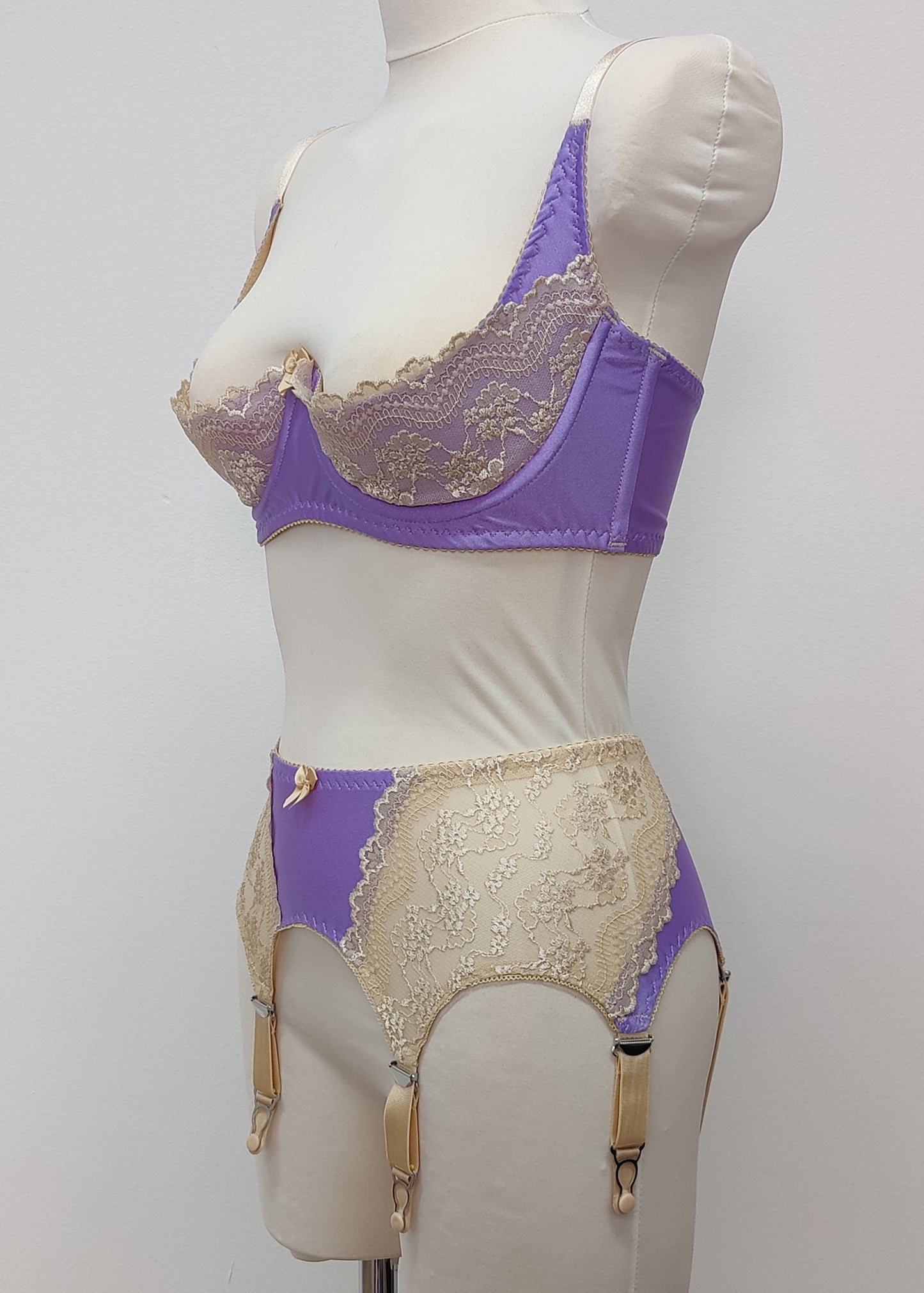 Lilac with beige lace 6 strap retro style Mona garter belt with side lace panels, shown with matching Lucy quarter cup bra, side view