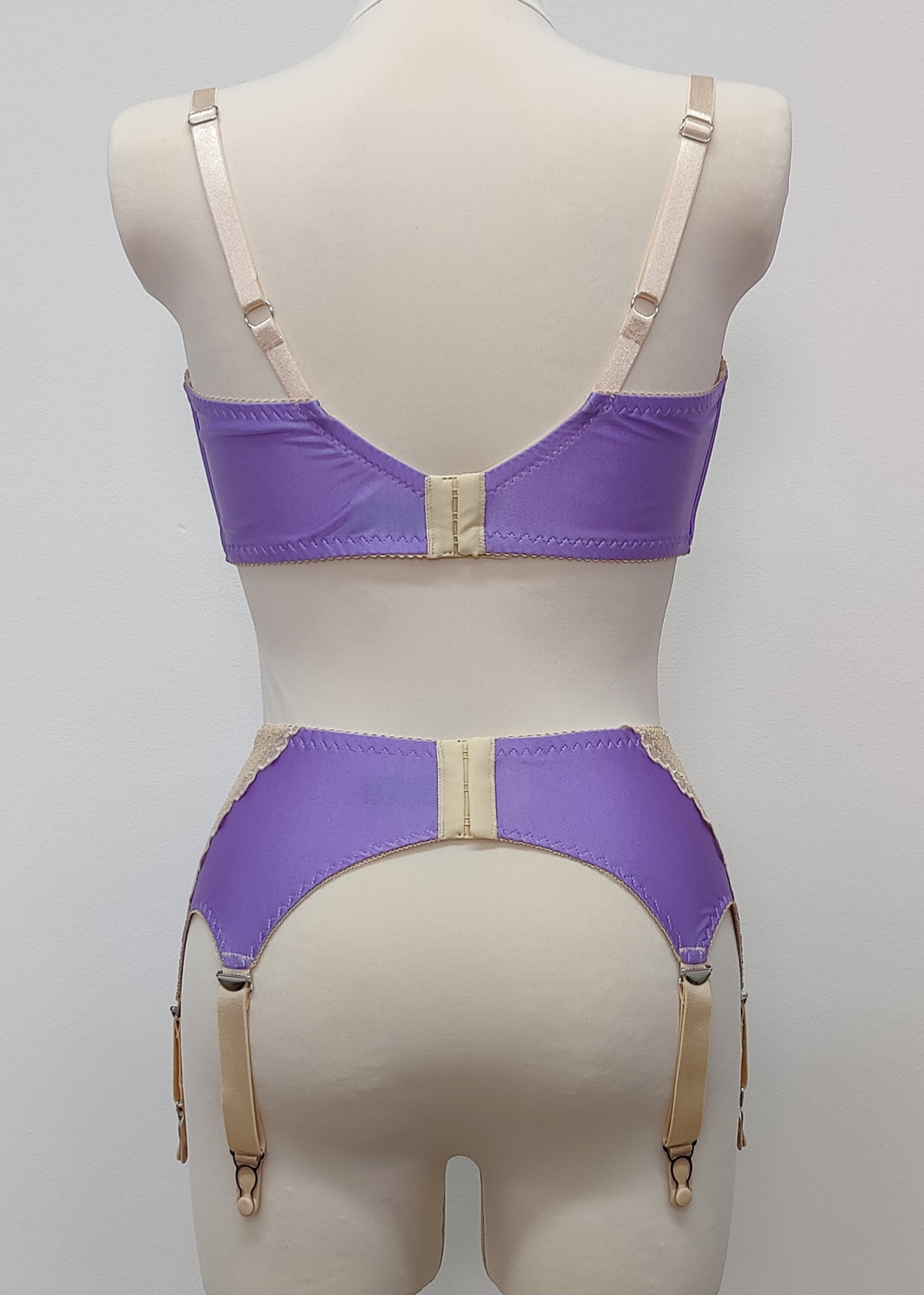 Lilac with beige lace 6 strap retro style Mona garter belt with side lace panels, shown with matching Lucy quarter cup bra, back view