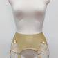 Beige high-waisted garter belt with lace side panels and hanging suspenders, displayed on a white mannequin torso against a light gray background.