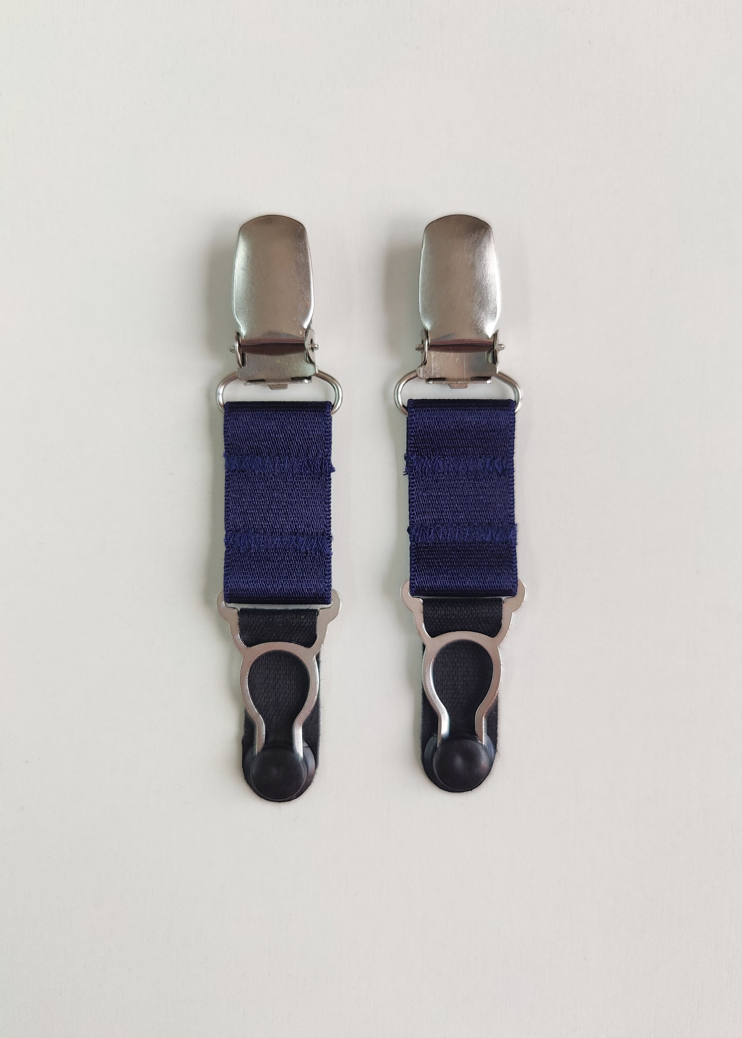 Pair of clip on suspenders with navy blue straps and metal stocking clips, 10cm /2" long