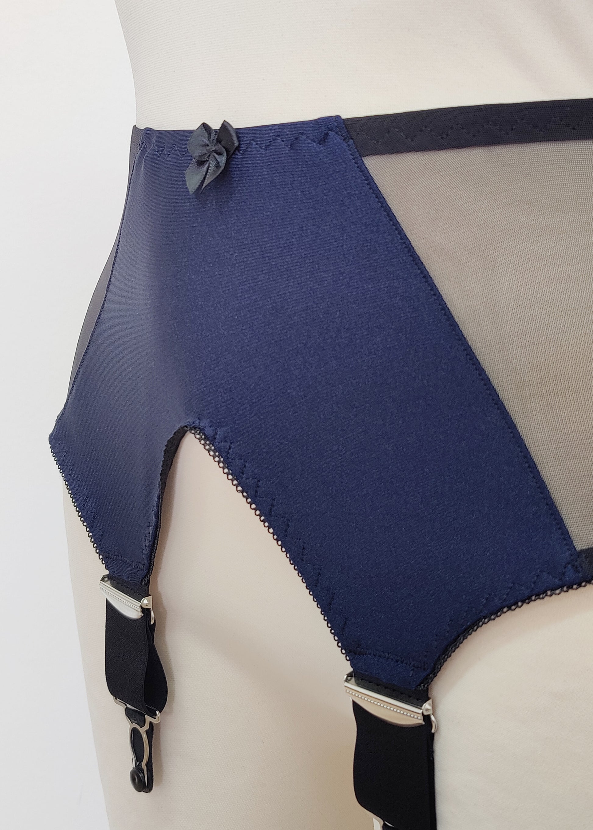 Dark blue high-waisted garter belt with extra wide black straps and bows