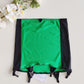 A green and black garter belt laid flat on a light background . The belt features a vibrant emerald green center panel, black side panels, black straps