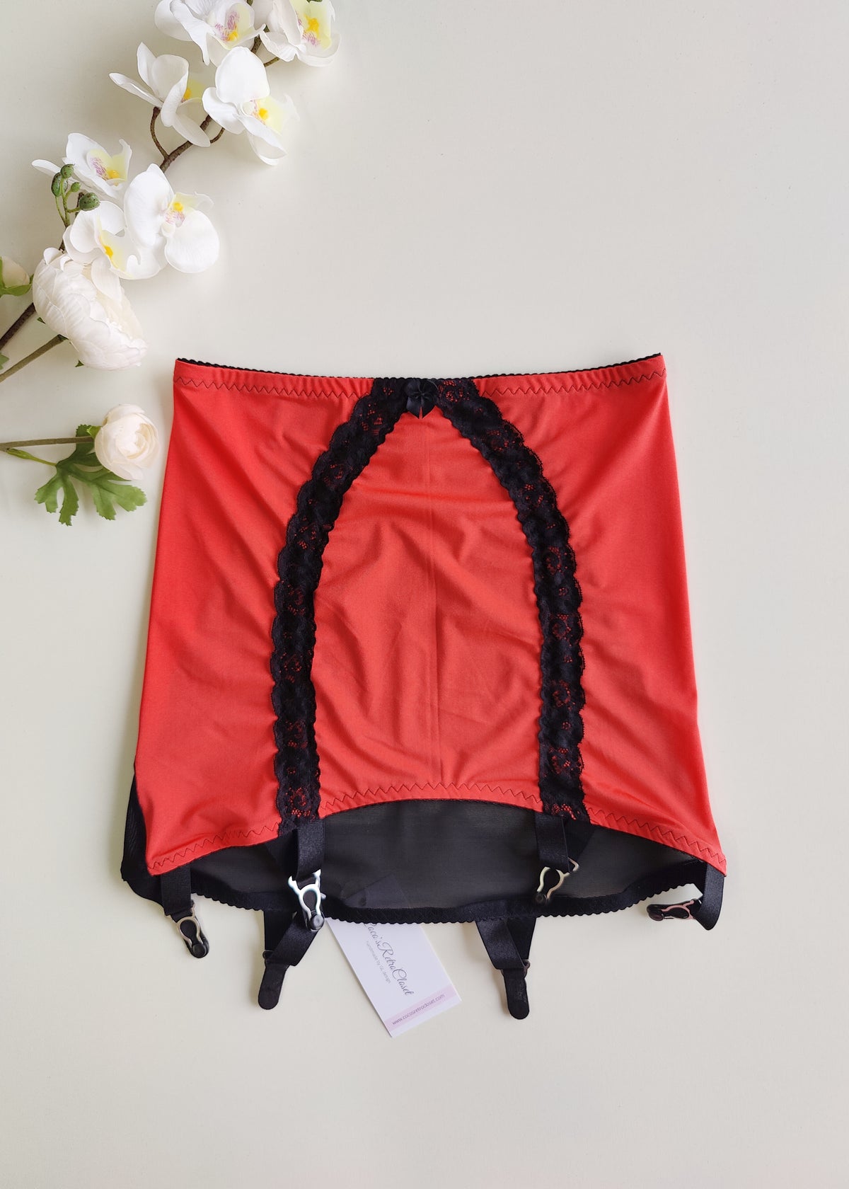 sunset red Rhonda open bottom girdle, with black lace trim on the front and 6 black straps