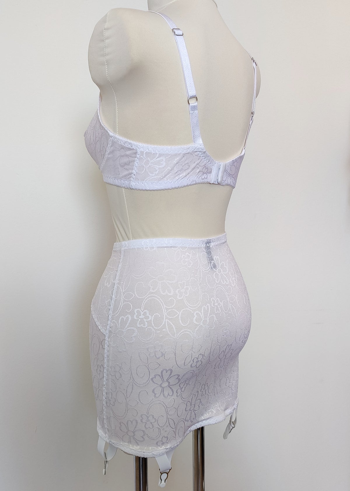 white Bella bralette with delicate shiny floral pattern, Here shown with matching Penelope girdle, back view