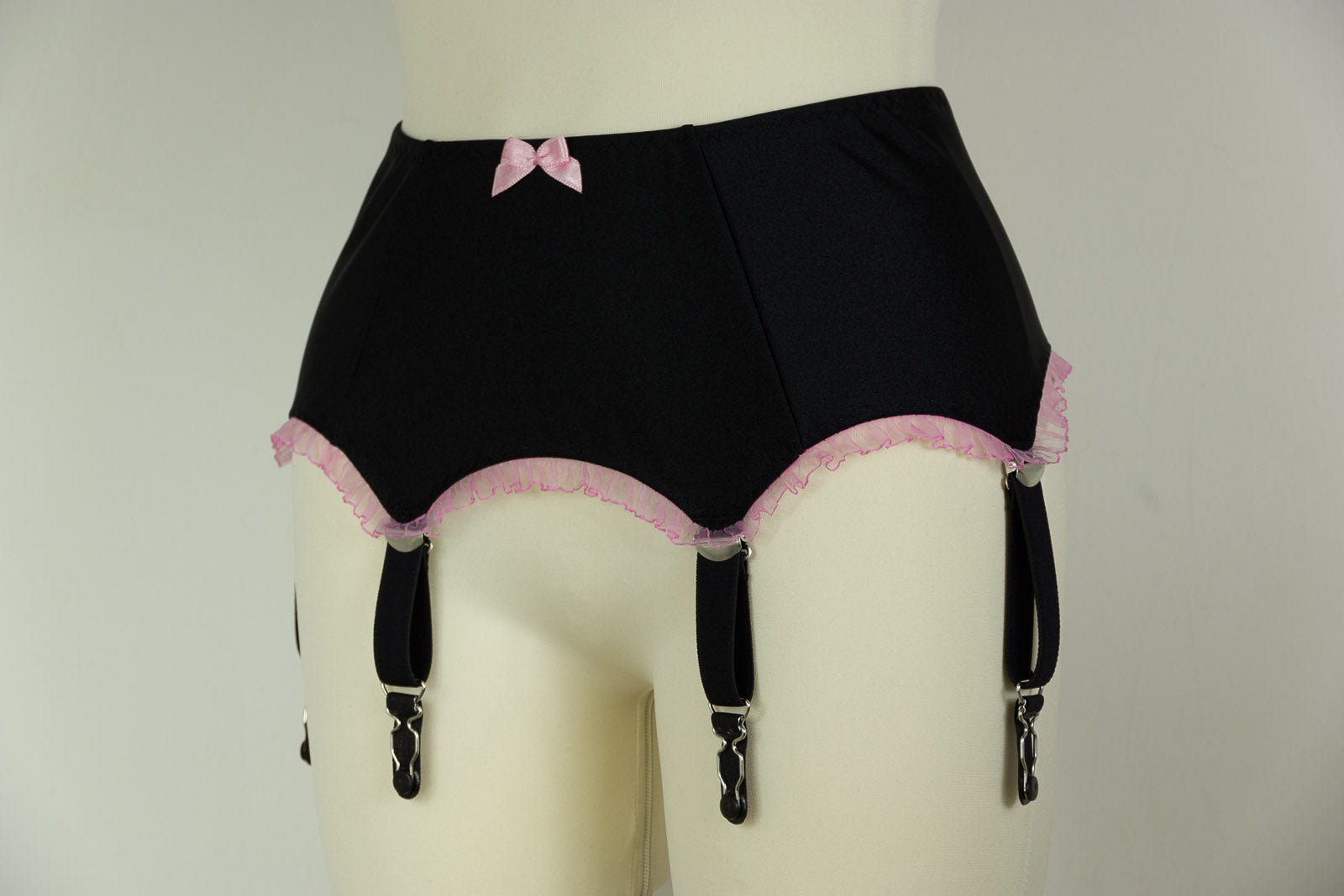 black 6 strap garter belt with pink ruffle trim