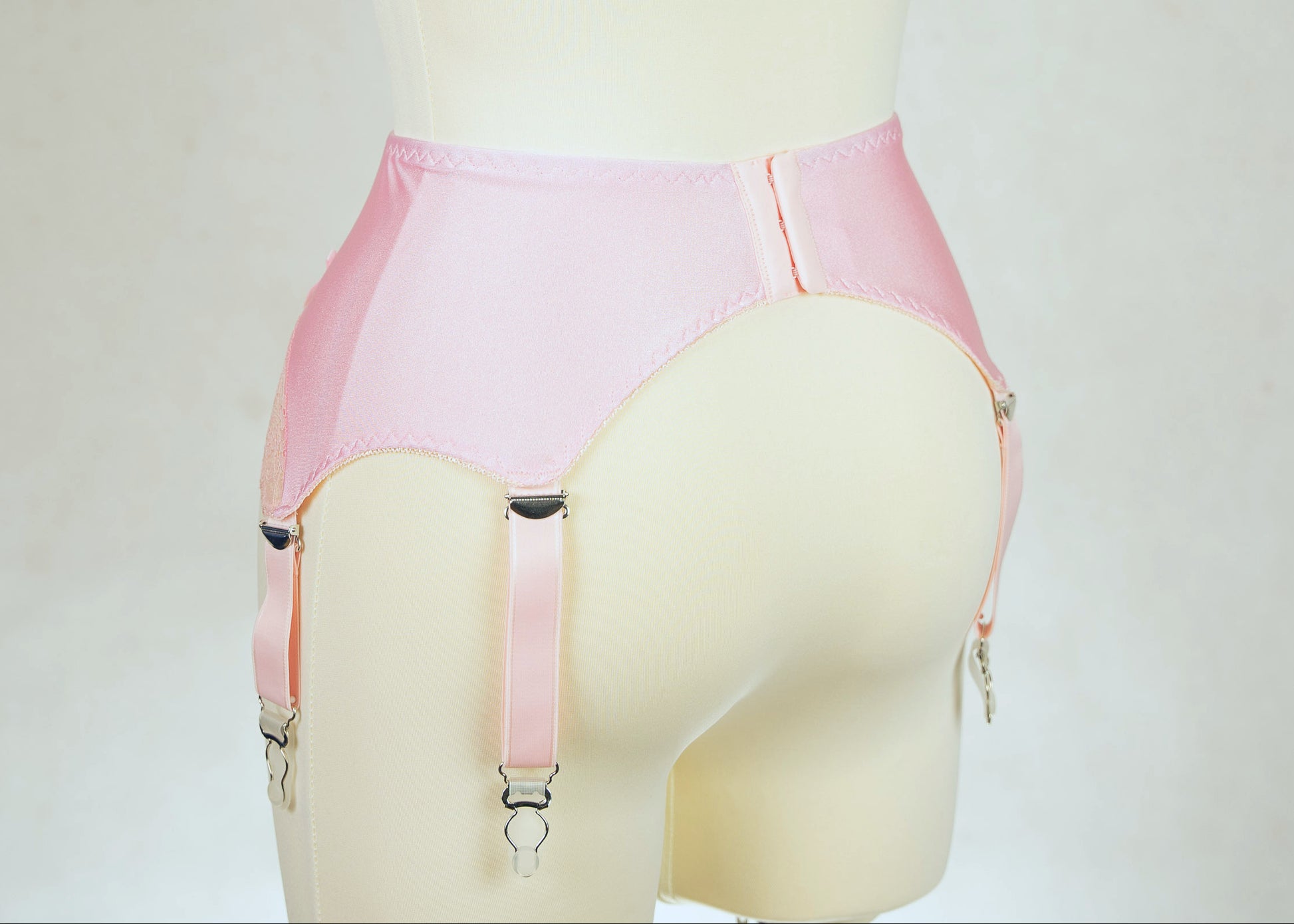 pink 6 strap garter belt with lace side panels, back view